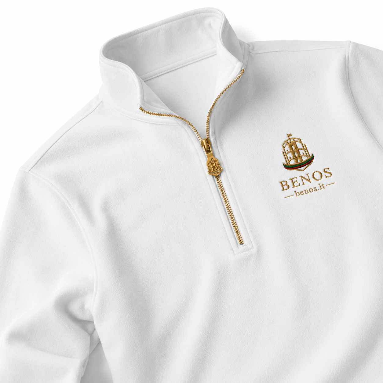 Macro detail of the gold quarter-zip and BENOS Citadel zipper pull on the white BENOS Sovereign Signature T-Shirt GEN 2