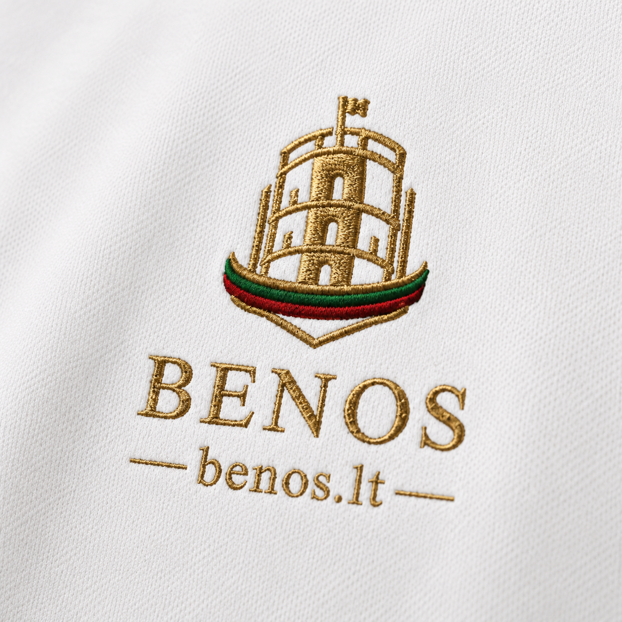 Macro detail of the embroidered BENOS Citadel emblem in gold, green, and red thread on the shirt fabric